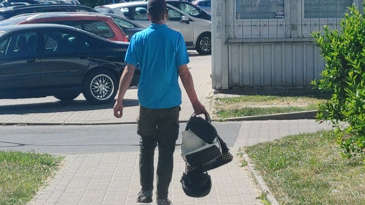 Bezdomny niosący kilka torebek