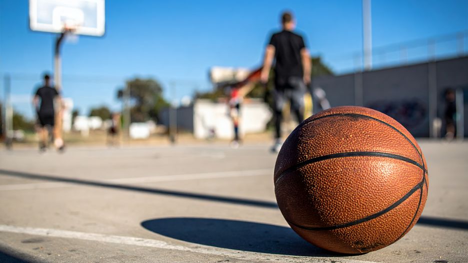 basketball, outdoor, court, streetball, recreation, sport, activity, ball, playing, game, exercise, fitness, competition, teamwork, summer, sunlight, urban, concrete, lines, hoop, net, leisure, fun, athlete, physical activity, training, practice, skills, playground, youth, weekend, day, bright, sunny, shadows, focus, close-up, perspective, action, dynamic, energy, lifestyle, healthy, community, neighborhood, public space
