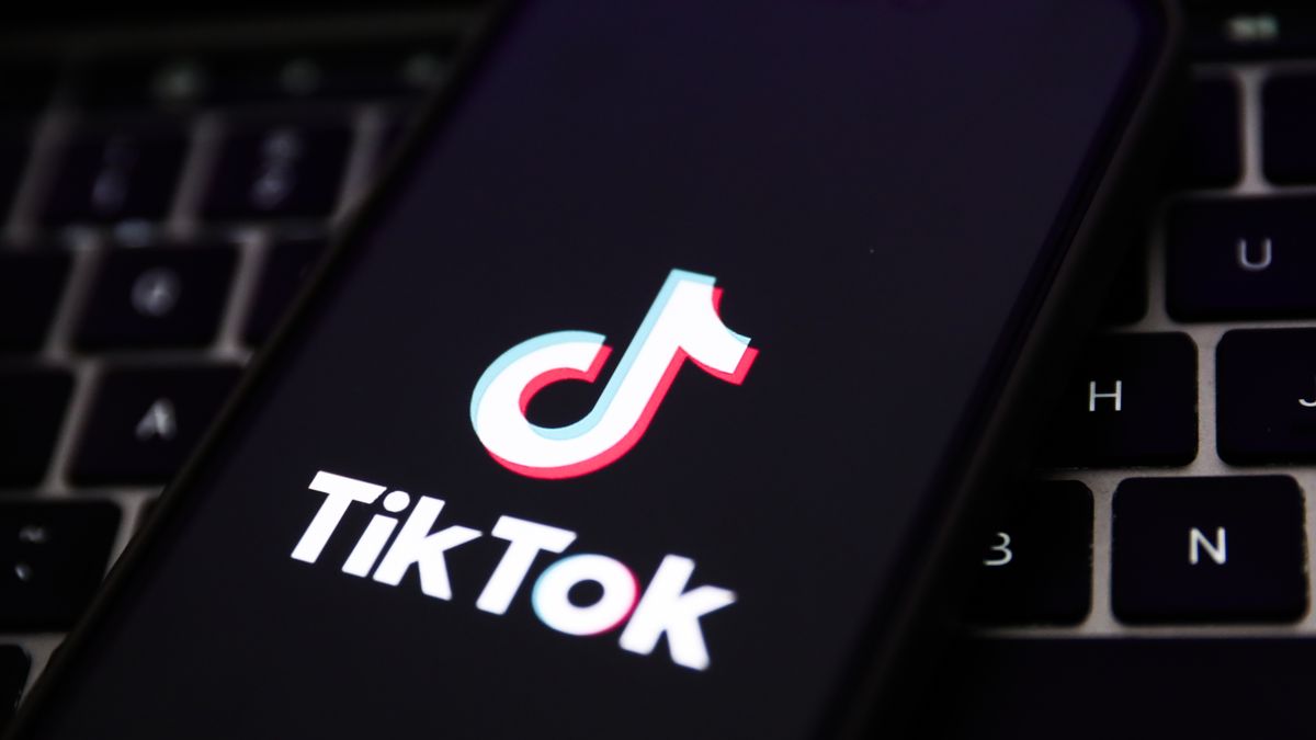 A laptop keyboard and TikTok logo displayed on a phone screen are seen in this illustration photo taken in Krakow, Poland on February 7, 2024. (Photo by Jakub Porzycki/NurPhoto via Getty Images)
