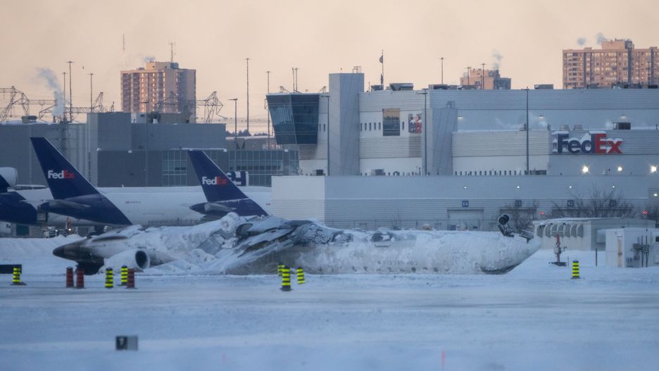 TORONTO, CANADA - FEBRUARY 18: The site of the snow-covered Delta Airline plane crash at Toronto Pearson International Airport on February 18, 2025 in Toronto, Canada. The jet coming in from Minneapolis attempted to land amid strong winds and snow, leading to it crashing and flipping over on the tarmac the day before. (Photo by Katherine KY Cheng/Getty Images)