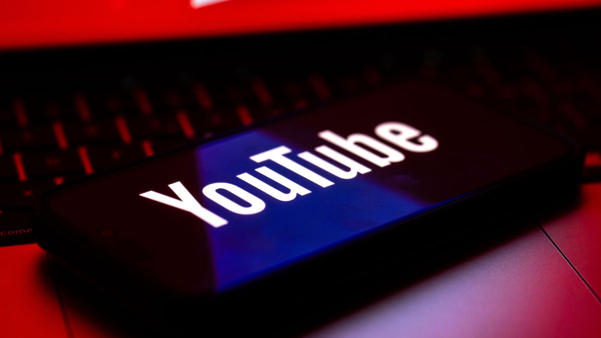 ANKARA, TURKIYE - OCTOBER 24: In this photo illustration the YouTube logo is displayed on a mobile phone screen above a computer in Ankara, Turkiye, on October 24, 2025. (Photo by Didem Mente/Anadolu via Getty Images)