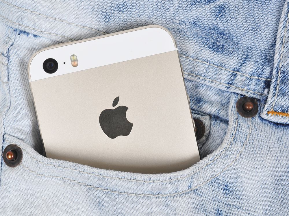 Gold iPhone 5s in a denim pocket