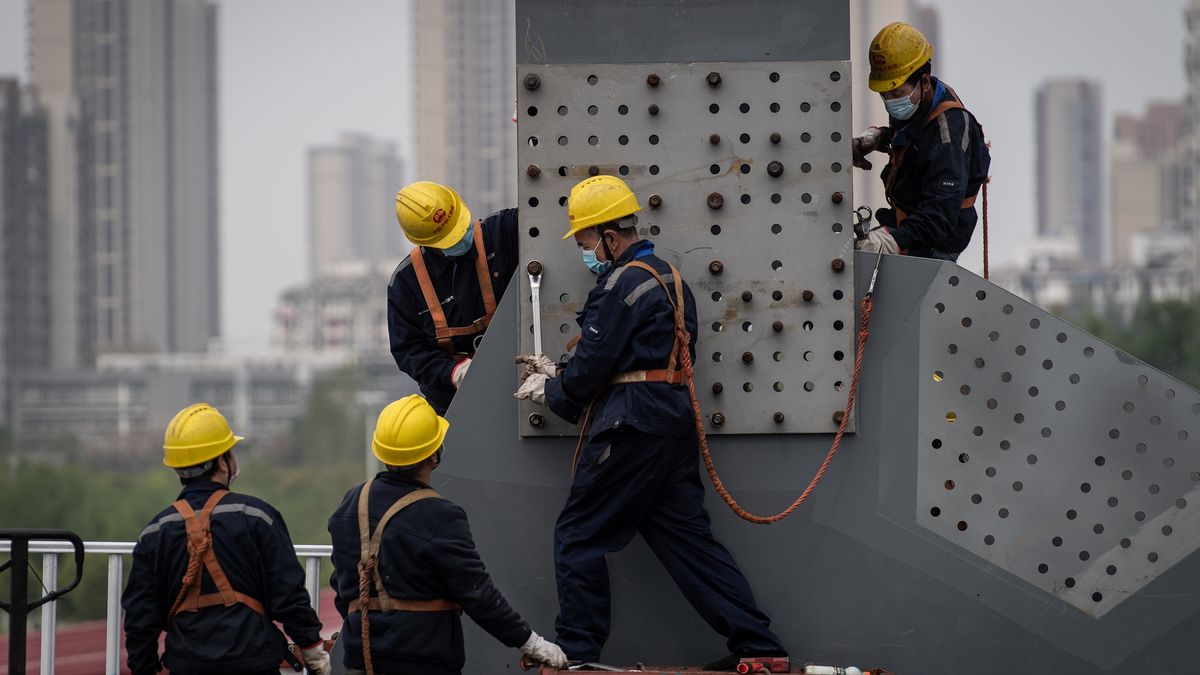 WUHAN, CHINA - MARCH 24 2020: Masked workers labor at the construction site of a bridge over Han River in Wuhan in central China's Hubei province Tuesday, March 24, 2020. The city will resume outbound traffic on April 8 after the over ten weeks of lockdown to contain the Covid-19.- PHOTOGRAPH BY Feature China / Barcroft Studios / Future Publishing (Photo credit should read Feature China/Barcroft Media via Getty Images)