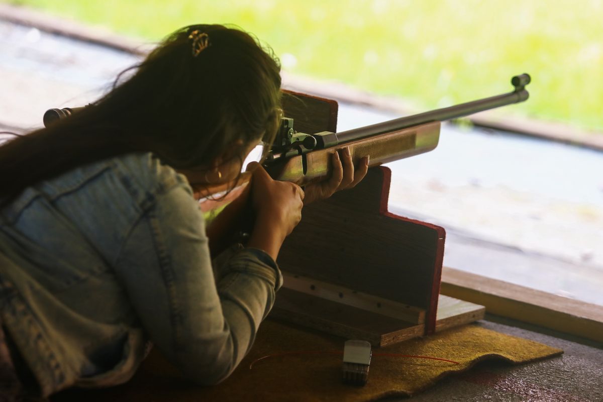 A woman aims a rifle at a shooting range in Krakow, Poland on June 21, 2022. (Photo by Jakub Porzycki/NurPhoto via Getty Images)