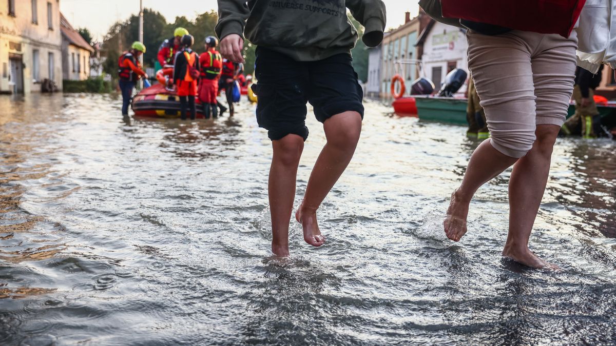 Residents walk away after being evacuated after Nysa Klodzka river flooded town of Lewin Brzeski in southwestern Poland, on September 17th, 2024. Storm Boris has caused rivers to burst banks in southern and southwest regions of Poland. Prime Minister of Poland declared a state of natural disaster in affected areas.  (Photo by Beata Zawrzel/NurPhoto via Getty Images)