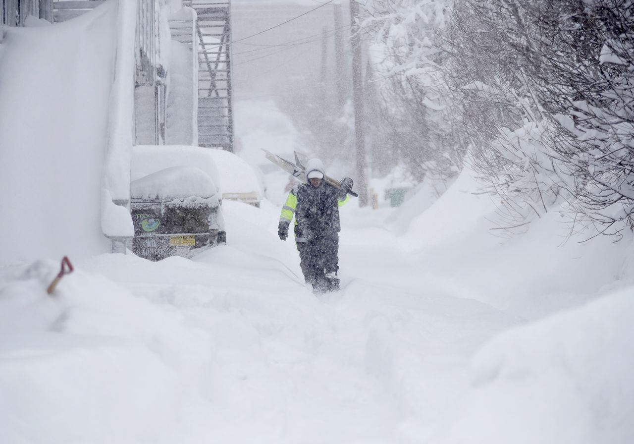 TRUCKEE, CALIFORNIA - MARCH 02: A worker carries shovels as snow continues to fall in downtown Truckee, Calif., on Saturday, March 2, 2024. (Jane Tyska/Digital First Media/East Bay Times via Getty Images)