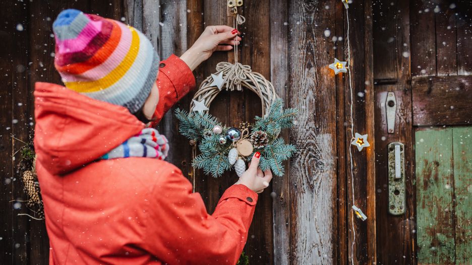 Rear view of young female hipsters decorate home for Christmas at the door outside. Beautiful Christmas tree wreath on old wooden rustic background.Rear view young female hipsters decorate home for Christmas door outside. Beautiful Christmas tree wreath old wooden rustic background. girl red jacket and a striped hat and scarf. New year 2020Shangarey Juliachristmas, holiday, beauty, woman, young, hipster, back, rustic, lifestyle, girl, new year, wooden, christmas tree, garland, handmade, wreath, decoration, happy, holding, home, people, pine, red, door, decorate, house, nature, 2020, outdoor, style, winter, hanging, hang, attractive, gift, xmas, bow, clothing, colorful, female, gorgeous, pretty, stylish, youth, background, tree, person, holly, pinecone, residence