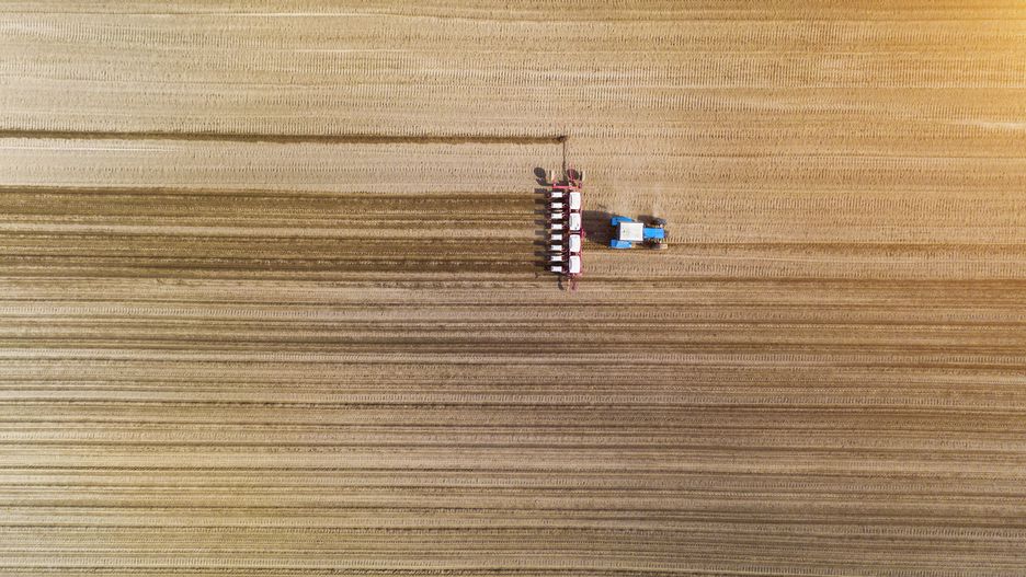 Aerial view of tractor with mounted seeder on the field
Aerial view of tractor with mounted seeder performing direct seeding of crops on plowed agricultural field. Farmer is using farming machinery for planting process, top view
Anton Petrus