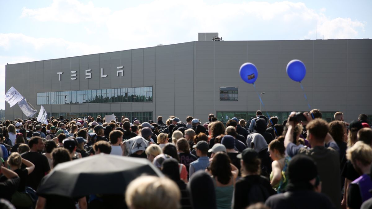 GRUENHEIDE, GERMANY - MAY 11: Environmental activists march in front of the Tesla plant in Gruenheide, southeast of Berlin on May 11, 2024. Activists have come from across Germany to demand a stop to plans by Tesla to expand the factory, which would involve cutting down at least 50 hectares of trees. Some locals also support the protest, citing stress to local groundwater reserves from the factory. (Photo by Maryam Majd/Getty Images)