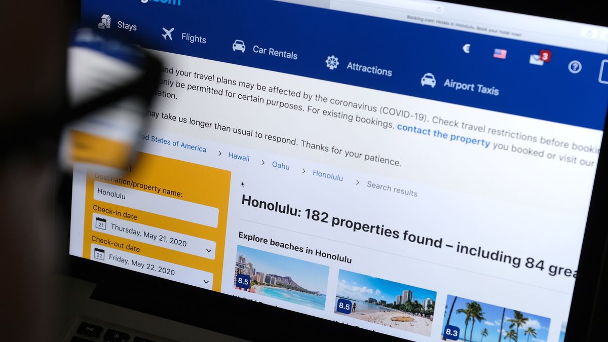 KATWIJK, NETHERLANDS - APRIL 20: In this photo illustration, a man looks at the website of Booking.com on April 20, 2020 in Katwijk, Netherlands.  (Photo by Yuriko Nakao/Getty Images)