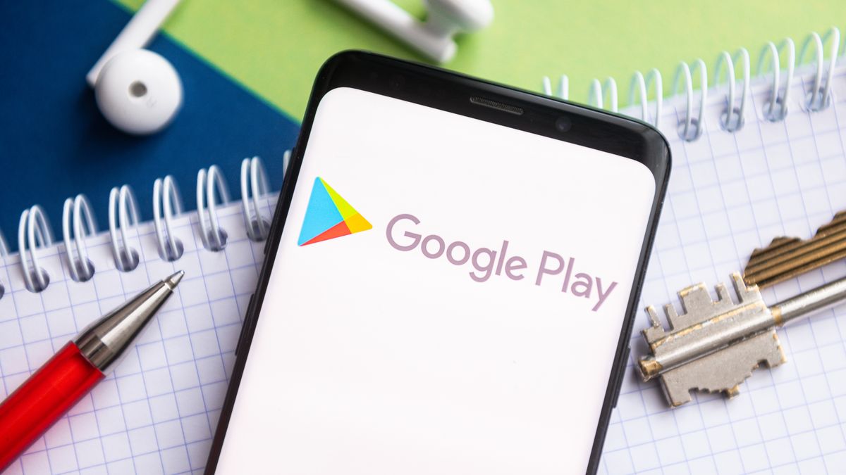 POLAND - 2021/02/09: In this photo illustration, a Google Play logo seen displayed on a smartphone with a pen, key, book and headsets in the background. (Photo Illustration by Mateusz Slodkowski/SOPA Images/LightRocket via Getty Images)