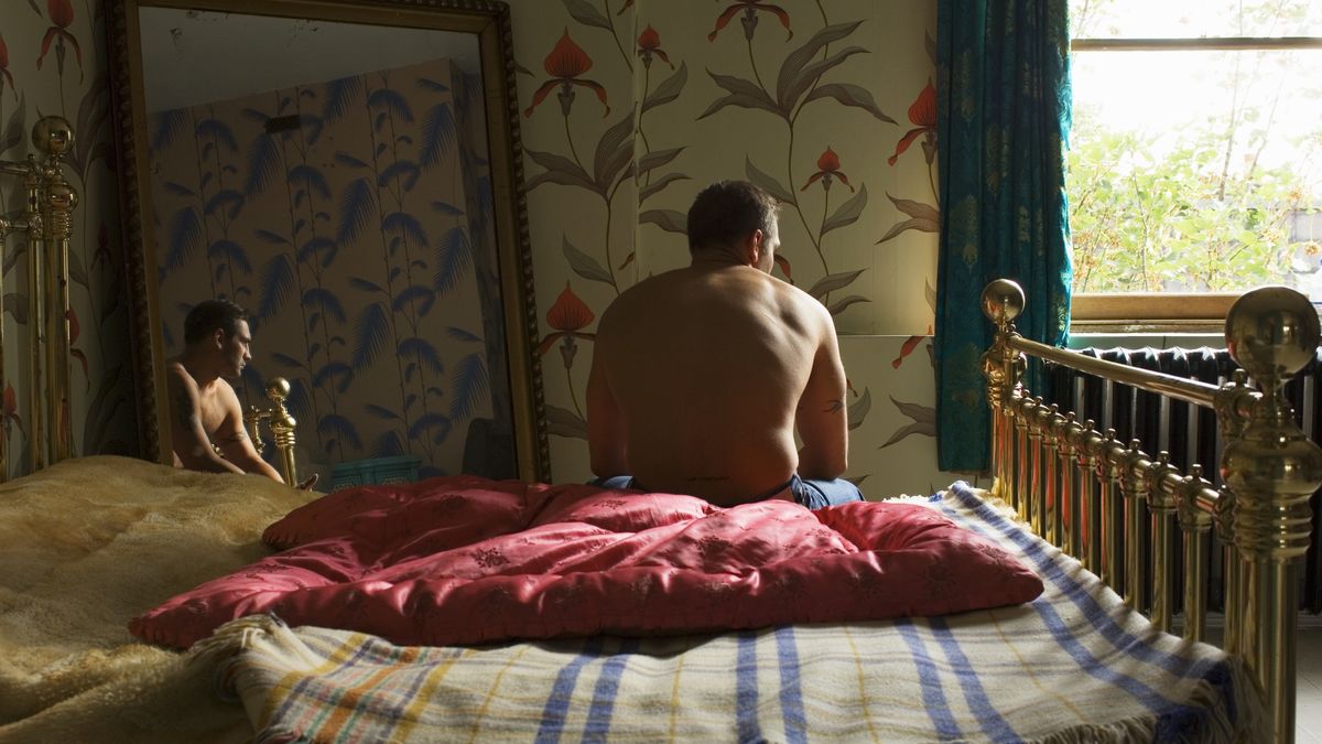 Young man sitting at edge of bed, reflection in mirror, rear view
Tara Moore
getting dressed, lonliness, sadness, solitude