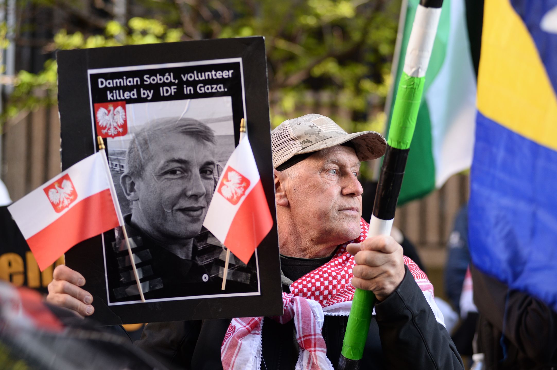 CHICAGO, ILLINOIS - APRIL 5: A protester holds a photo of Damian Sobol from World Central Kitchen during a pro-Palestinian protest outside the Israeli consulate in Chicago, Illinois, United States on April 5, 2024. Damian Sobol was a Polish volunteer who was killed during a humanitarian mission in Gaza on April 1, 2024. (Photo by Jacek Boczarski/Anadolu via Getty Images)