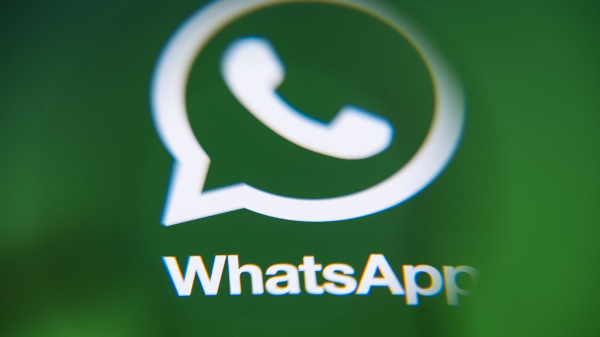 In Créteil, France, on September 29, 2025, the WhatsApp logo appears on a smartphone viewed through a magnifying glass, reflecting a green illustration. Meta, the parent company of WhatsApp and Meta AI, makes the Artificial Intelligence assistant mandatory in its instant messaging app. (Photo Illustration by Samuel Boivin/NurPhoto via Getty Images)