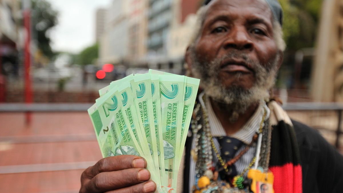 Economical Crisis in Zimbabwe
HARARE, ZIMBABWE - NOVEMBER 28: A man poses for a photograph with new banknotes as Zimbabwe Central bank launches new banknotes due to economical crisis in the country and decreasing of cash stores, in Harare, Zimbabwe on November 28, 2016. (Photo by Wilfred Kajese/Anadolu Agency/Getty Images)
Anadolu Agency
Zimbabwe, money, Harare, cash, Photograph, economical crisis, banknotes