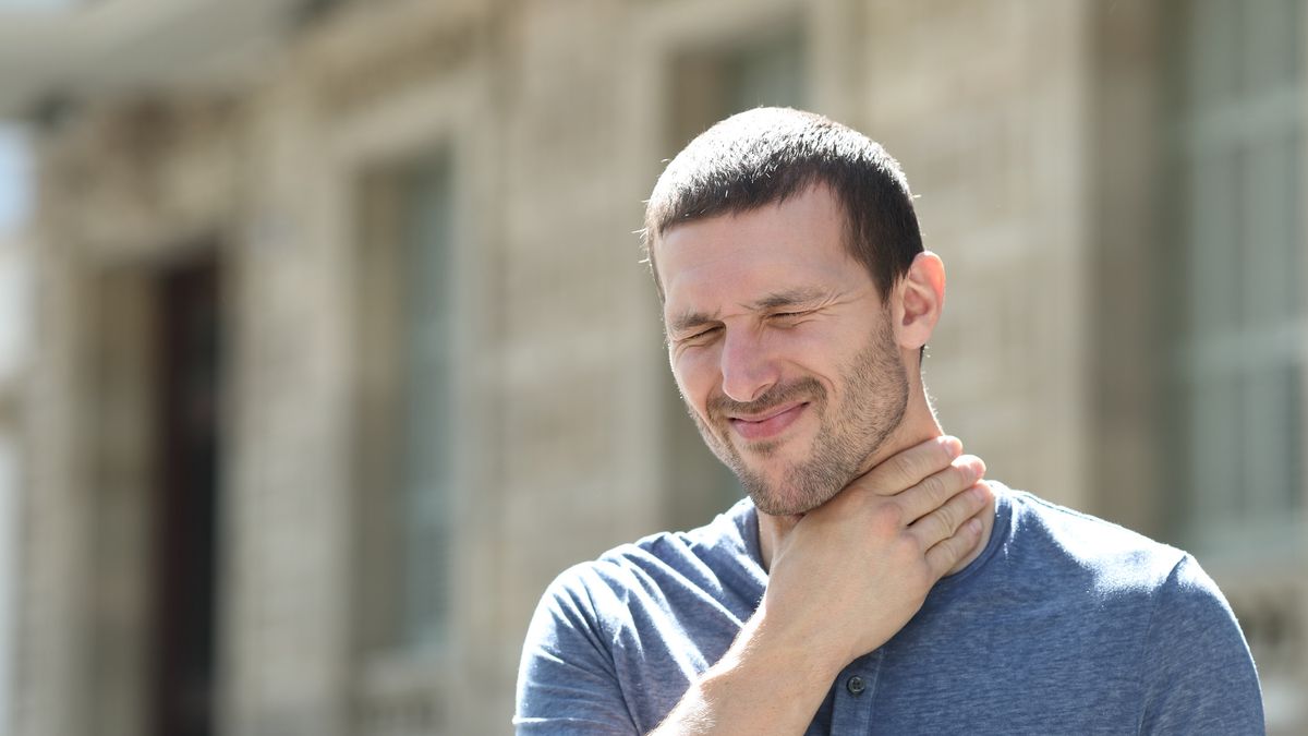 Man in pain suffering sore throat in the streetMan in pain suffering sore throat in the streetAntonioGuillem