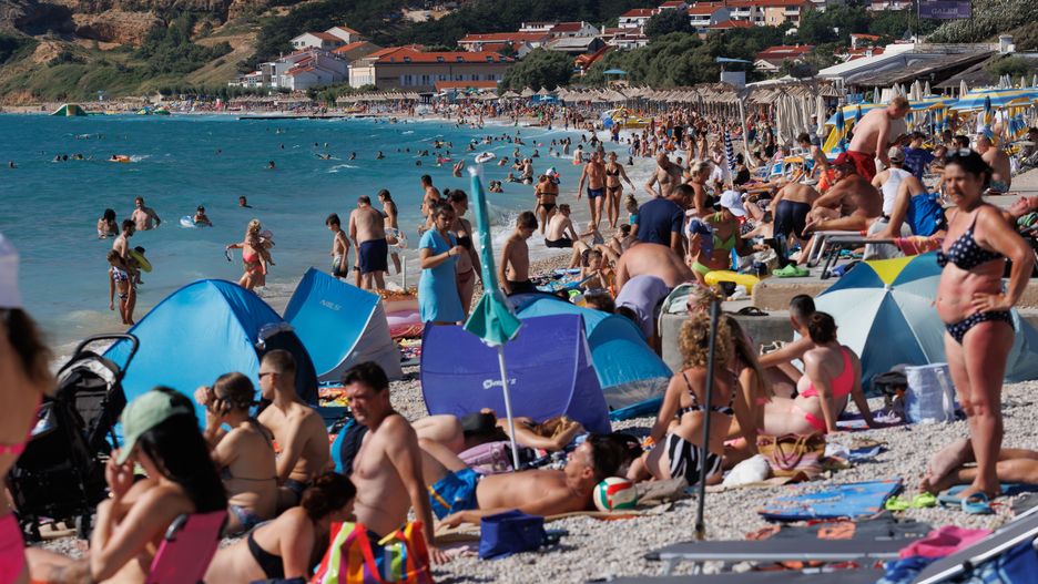 People are seen at city beach in Baska at Island Krk, Croatia on August15, 2023. This year's tourist season is at the level of the pre-pandemic, record-breaking 2019. Croatia is now recording 12.5 million arrivals and 63 million overnight stays. (Photo: Nel Pavletic/PIXSELL/DeFodi Images News/Getty Images)