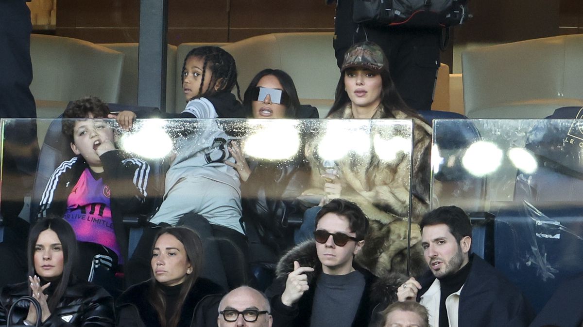 PARIS, FRANCE - MARCH 19: Kim Kardashian holding her son Saint West, Kendall Jenner attend the Ligue 1 Uber Eats match between Paris Saint-Germain (PSG) and Stade Rennais (Rennes) at Parc des Princes stadium on March 19, 2023 in Paris, France. (Photo by Jean Catuffe/Getty Images)