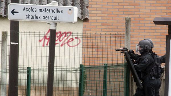 Policjant z jednostki antyterrorystycznej przed szkołą