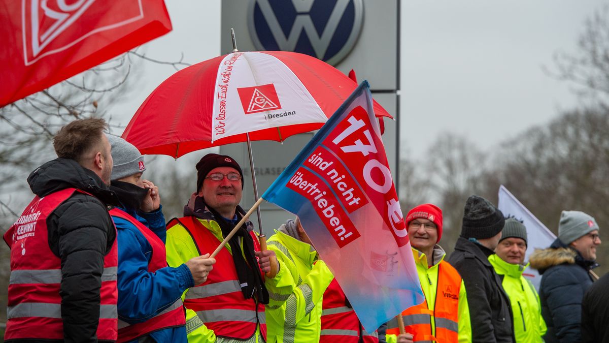 DRESDEN, GERMANY - DECEMBER 9: Workers of the Volkswagen Dresden electric car factory gather for a second warning strike and demonstration on December 9, 2024 in Dresden, Saxony, Germany. IG Metall, the labour union representing the workers, is leading strikes at Volkswagen plants nationwide today as negotiations continue over wages. IG Metall is demanding a 7% wage increase, while Volkswagen management is seeking a 10% cut in wages in an effort to restore profitability. The company has experienced a sharp decline in global automobile sales this year. (Photo by Craig Stennett/Getty Images)