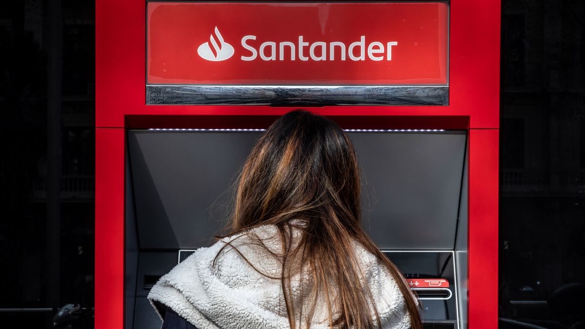 A customer uses an automated teller machine (ATM) outside a Banco Santander SA bank branch in Barcelona, Spain, on Monday, Jan. 31, 2022. Santander reports full year earnings on February 2. Photographer: Angel Garcia/Bloomberg via Getty Images