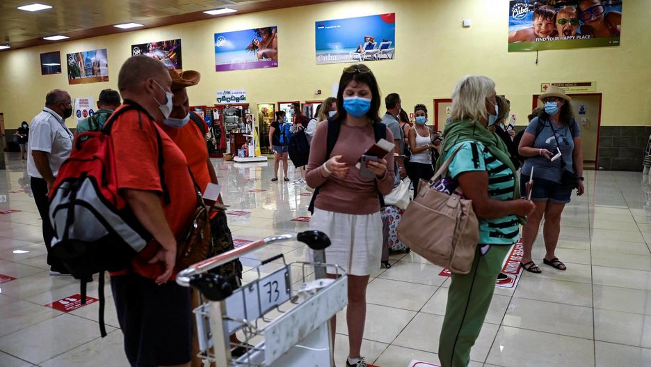 TemporaryRussian tourists wait to board a charter flight to Russia at Juan Gualberto Gomez airport in Varadero, Cuba on March 6, 2022. - At least 927 Russians flew to their country on March 6, 2022 from the Cuban resort of Varadero, where some even had to suspend their vacations to return, due to the international blockade of Russian planes by the United States and Europe. (Photo by YAMIL LAGE / AFP)YAMIL LAGE