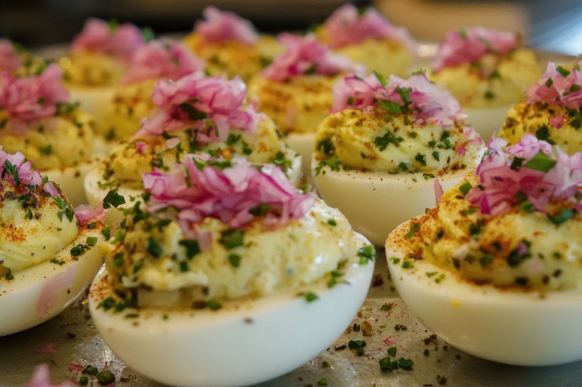 Stuffed eggs get a muffuletta twist with olive tapenade