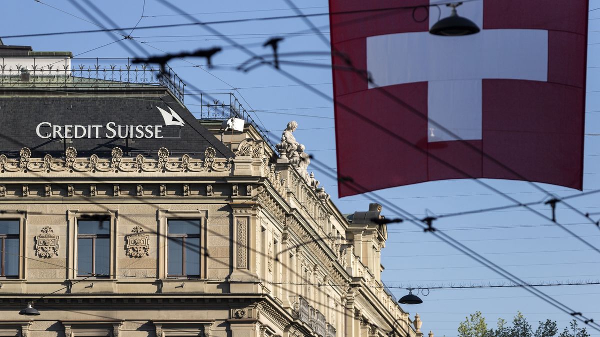 FILE: A Swiss flag hangs beyond Credit Suisse Group AG's headquarters in Zurich, Switzerland, on Friday, April 24, 2015. Credit Suisse Group AG said Chief Executive Officer Tidjane Thiam is resigning, a stunning reversal for the executive who was backed by key shareholders after a damaging spying scandal. Photographer: Alessandro Della Bella/Bloomberg via Getty Images