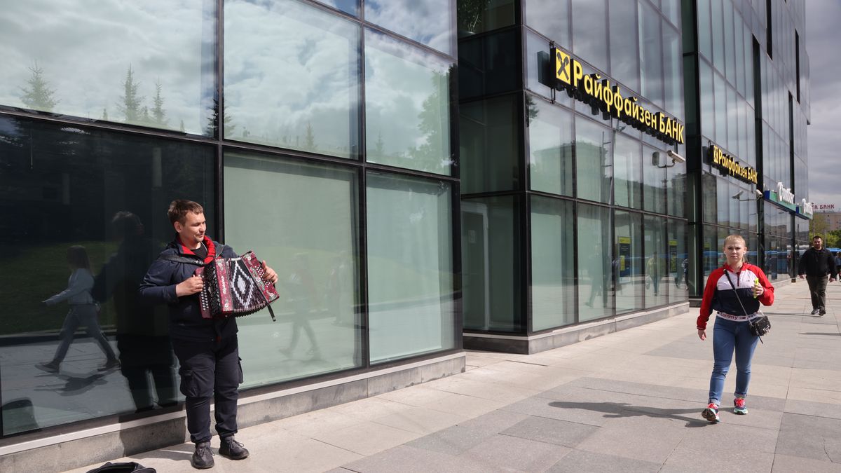 MOSCOW, RUSSIA - MAY 14: (RUSSIA OUT) A man plays an accordion near the branch of Raiffeisen bank on May 14, 2023 in Moscow, Russia. Austrian Raiffeisen Bank International AG (RBI) announced it was selling off its Russian banking business due to Western sanctions. (Photo by Contributor/Getty Images)