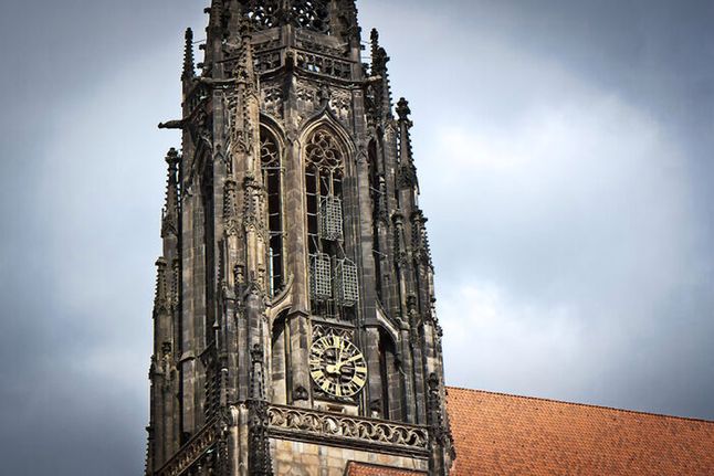 Widoczne nad zegarem 3 klatki służyły do przechowywania poćwiartowanych szczątków przewódców religijnych w XVI wieku. Münster, Niemcy.