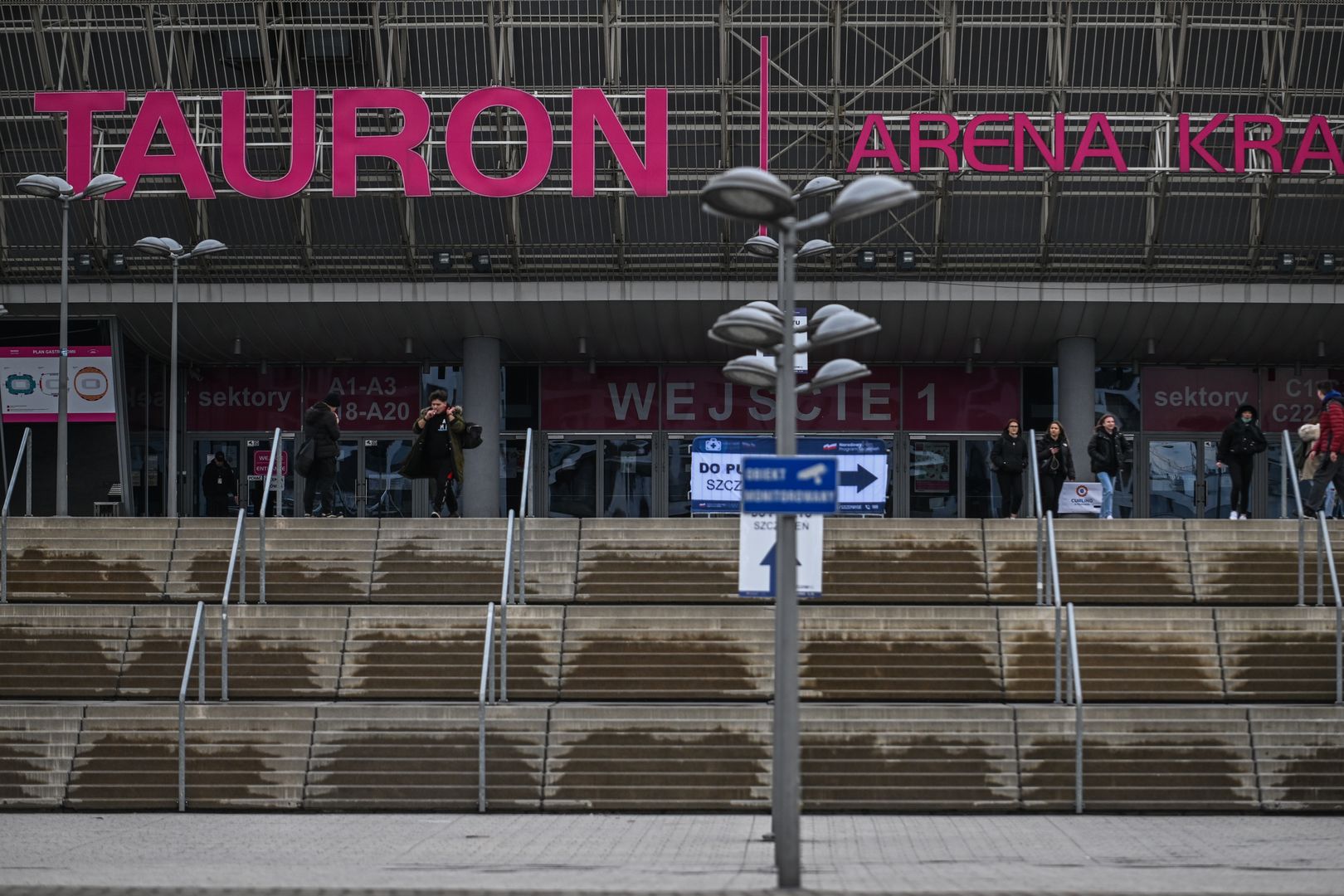 KRAKOW, POLAND - FEBRUARY 21: People walk past Krakow's multifunctional sports and entertainment hall Tauron Arena on February 21, 2022 in Krakow, Poland. lately, Poland's Ministry of Interior and Administration asked cities to indicate a list of accommodation/facilities for refugees, the number of people acceptable and the costs associated with it in case of a huge influx of refugees. The fear of a Russian invasion continues to escalate and .U.S. President Joe Biden warned that he believes Russian forces intend to attack Ukraine "in the coming week" or sooner. (Photo by Omar Marques/Getty Images)