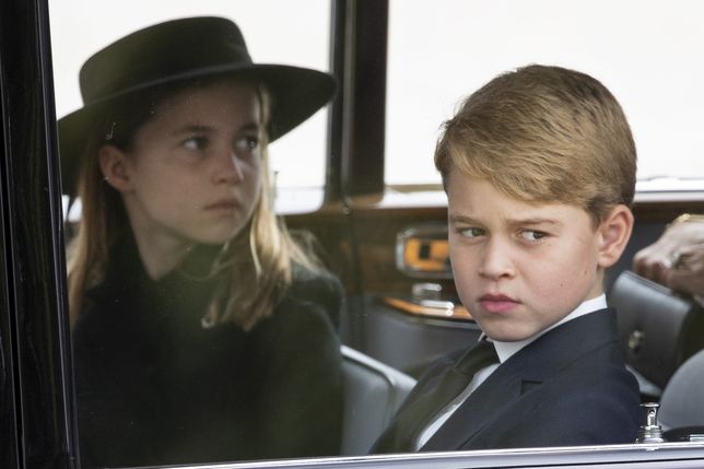 The State Funeral Of Queen Elizabeth IILONDON, ENGLAND - SEPTEMBER 19: Princess Charlotte of Wales and Prince George of Wales follow the cortège of the late Queen Elizabeth II as it is pulled past the Houses of Parliament after her funeral at Westminster Abbey on September 19, 2022 in London, England. Elizabeth Alexandra Mary Windsor was born in Bruton Street, Mayfair, London on 21 April 1926. She married Prince Philip in 1947 and ascended the throne of the United Kingdom and Commonwealth on 6 February 1952 after the death of her Father, King George VI. Queen Elizabeth II died at Balmoral Castle in Scotland on September 8, 2022, and is succeeded by her eldest son, King Charles III. (Photo by Joshua Bratt- WPA Pool/Getty Images)WPA Poolroyals death horizontal