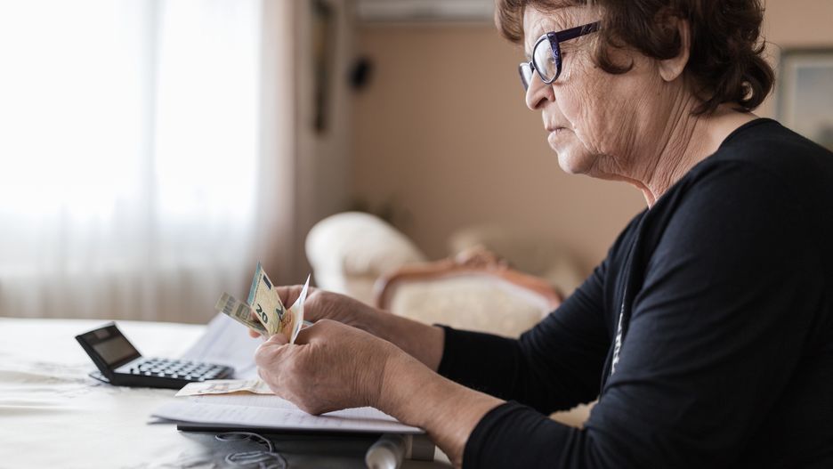 Senior woman holding money in her hands at home
Worried older woman sitting at a table and calculating her expenses
Dobrila Vignjevic