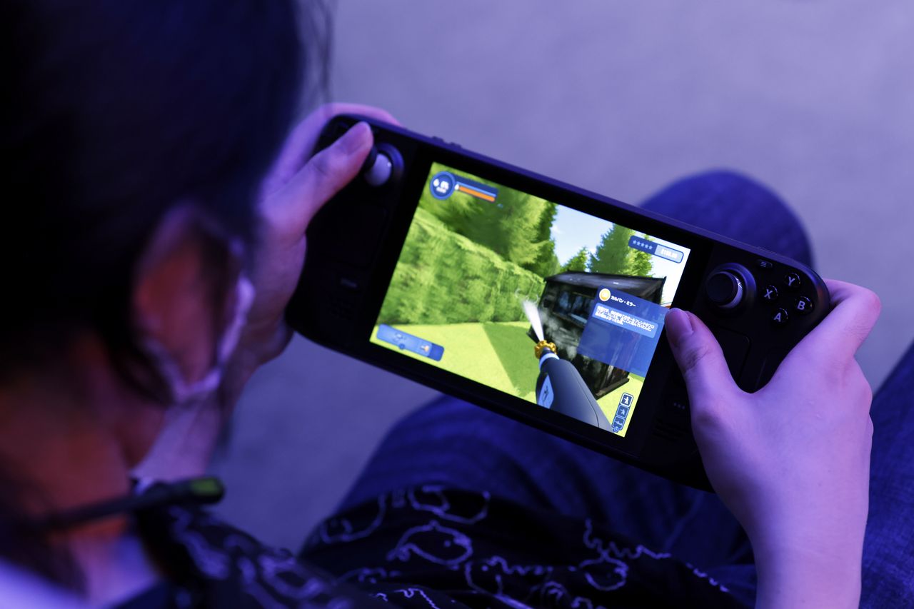 An attendee plays a video game on a Valve Corp. Steam Deck handheld gaming computer at the Tokyo Game Show 2022 in Chiba, Japan, on Thursday, Sept. 15, 2022. The show runs through to Sept. 18. Photographer: Kiyoshi Ota/Bloomberg via Getty Images