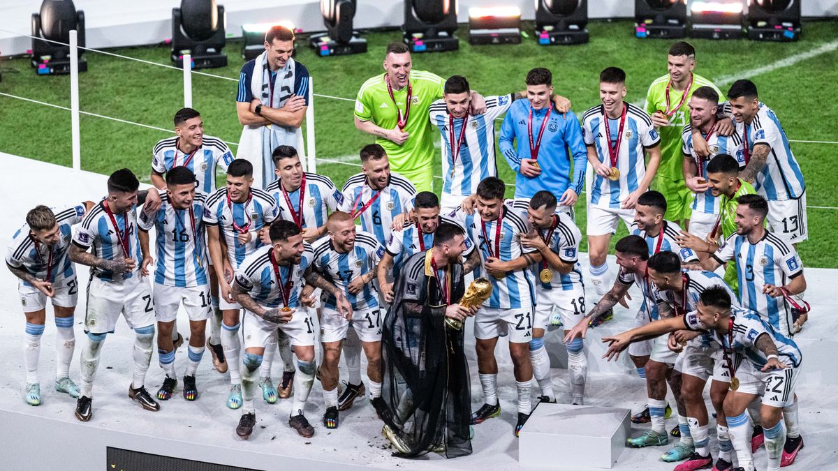 LUSAIL CITY, QATAR - DECEMBER 18: Lionel Messi (C) of Argentina brings the World Cup trophy to his teammates after the FIFA World Cup Qatar 2022 Final match between Argentina and France at Lusail Stadium on December 18, 2022 in Lusail City, Qatar. (Photo by Markus Gilliar - GES Sportfoto/Getty Images)