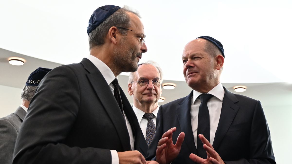 DESSAU, GERMANY - OCTOBER 22: The German Chancellor Olaf Scholz (R, SPD) wearing a kippah, speaks with Felix Klein, Federal Government Commissioner for Jewish Life in Germany and the fight against anti-Semitism, with Reiner Haseloff (CDU), Prime Minister of Saxony-Anhalt, standing in between them at the official inauguration of the Weill Synagogue on October 22, 2023 in Dessau, Germany. The synagogue, named after musical composer and Dessau native Kurt Weill, is the first to be built in Dessau since the destruction of the New Synagogue during the Nazi-era "Kristallnacht" pogroms of 1938. The synagogue will serve the local Jewish community, which has grown significantly since the 1990s, mainly due to the influx of Jews from the former Soviet Union. The opening is taking place as emotions among Germany's Jewish and Arab and Muslim communities are high due to the ongoing conflict in Gaza between Israel and Hamas. (Photo by Hendrik Schmidt - Pool/Getty Images)