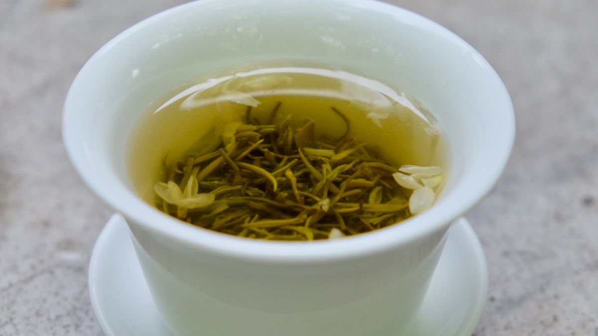 close up clear tea water in retro white Chinese tea cup. Blur backgroundIn Chengdu China. Chinese tea culture conceptRobert Way