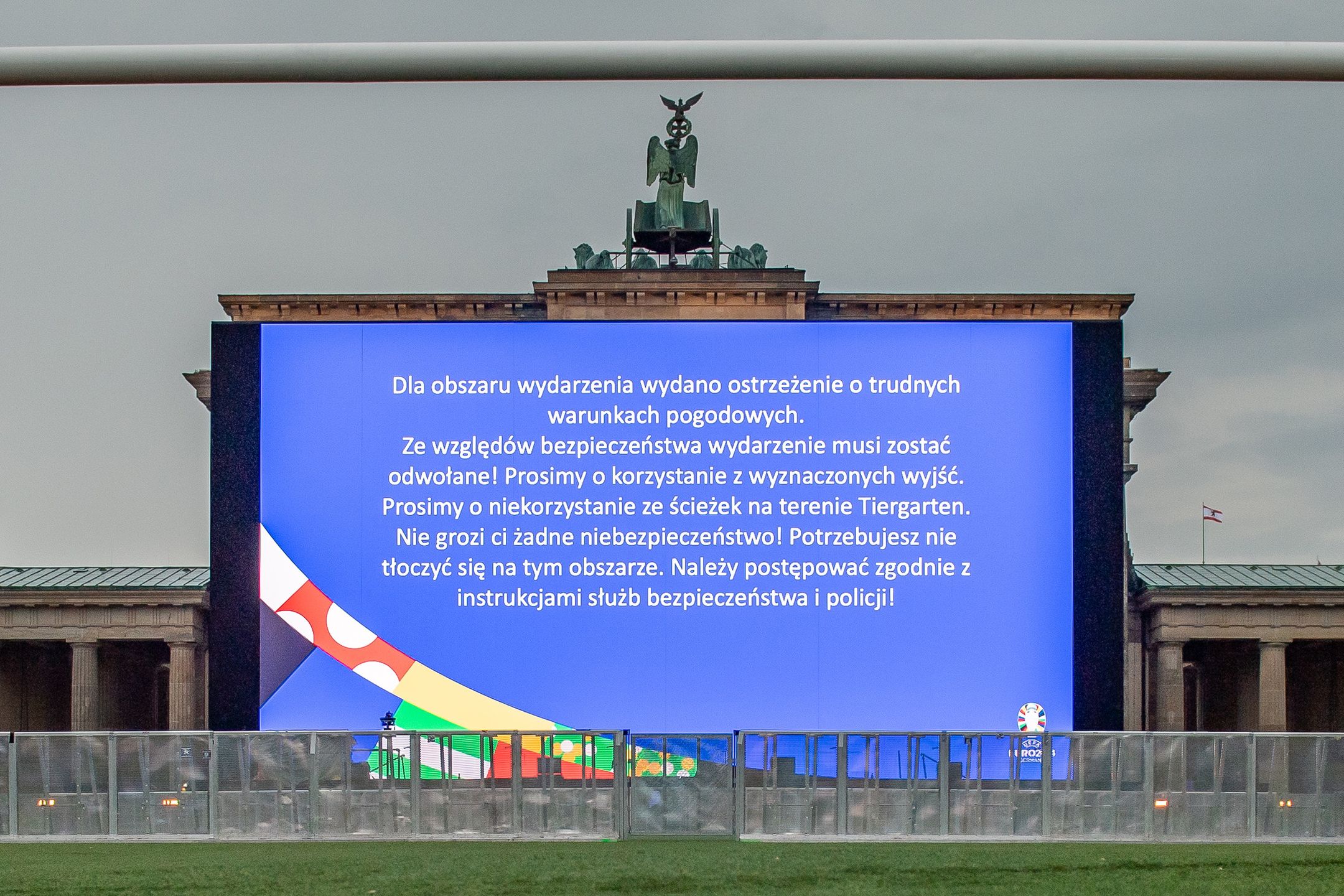 BERLIN, GERMANY - JUNE 21: Big screen shows a message in Polish asking the fans to evacuate the area due to bad weather at the official UEFA Fan Zone during the Group D match between Austria and Poland on June 21, 2024 in Berlin, Germany. (Photo by Luciano Lima - UEFA/UEFA via Getty Images)