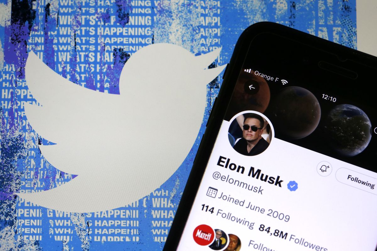 PARIS, FRANCE - APRIL 26: In this photo illustration, the Elon Musk’s Twitter account is displayed on the screen of an iPhone in front of the homepage of the Twitter website on April 26, 2022 in Paris, France. The U.S. multi-billionaire Elon Musk bought the social network Twitter on Monday April 25 for the sum of 44 billion dollars after two weeks of arm wrestling with the company's board of directors. (Photo illustration by Chesnot/Getty Images)