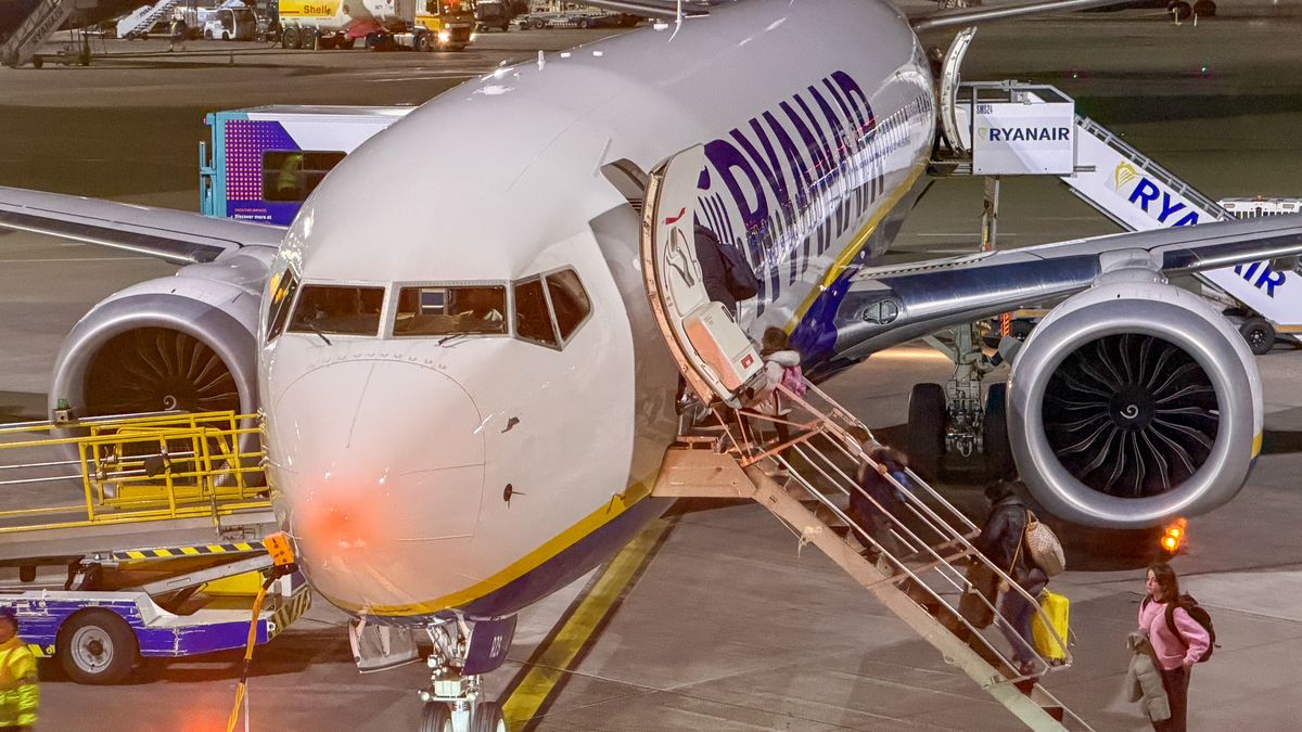 DUBLIN, IRELAND - NOVEMBER 01: Passengers board a Ryanair aircraft that is parked on the runaway at Dublin Airport, on November 1, 2025 in Dublin, Ireland. With projections for passenger traffic to more than double by 2050, aviation carbon emissions are projected to increase, especially in relation to other sectors as their emissions decline. Global commitments to reducing future Co2 carbon emissions will mean a huge investment is needed in green and renewable energy sources and infrastructure such as solar and wind farms so that economies can transition from getting energy from carbon and fossil fuels to that generated by clean sources. (Photo by Matt Cardy/Getty Images)