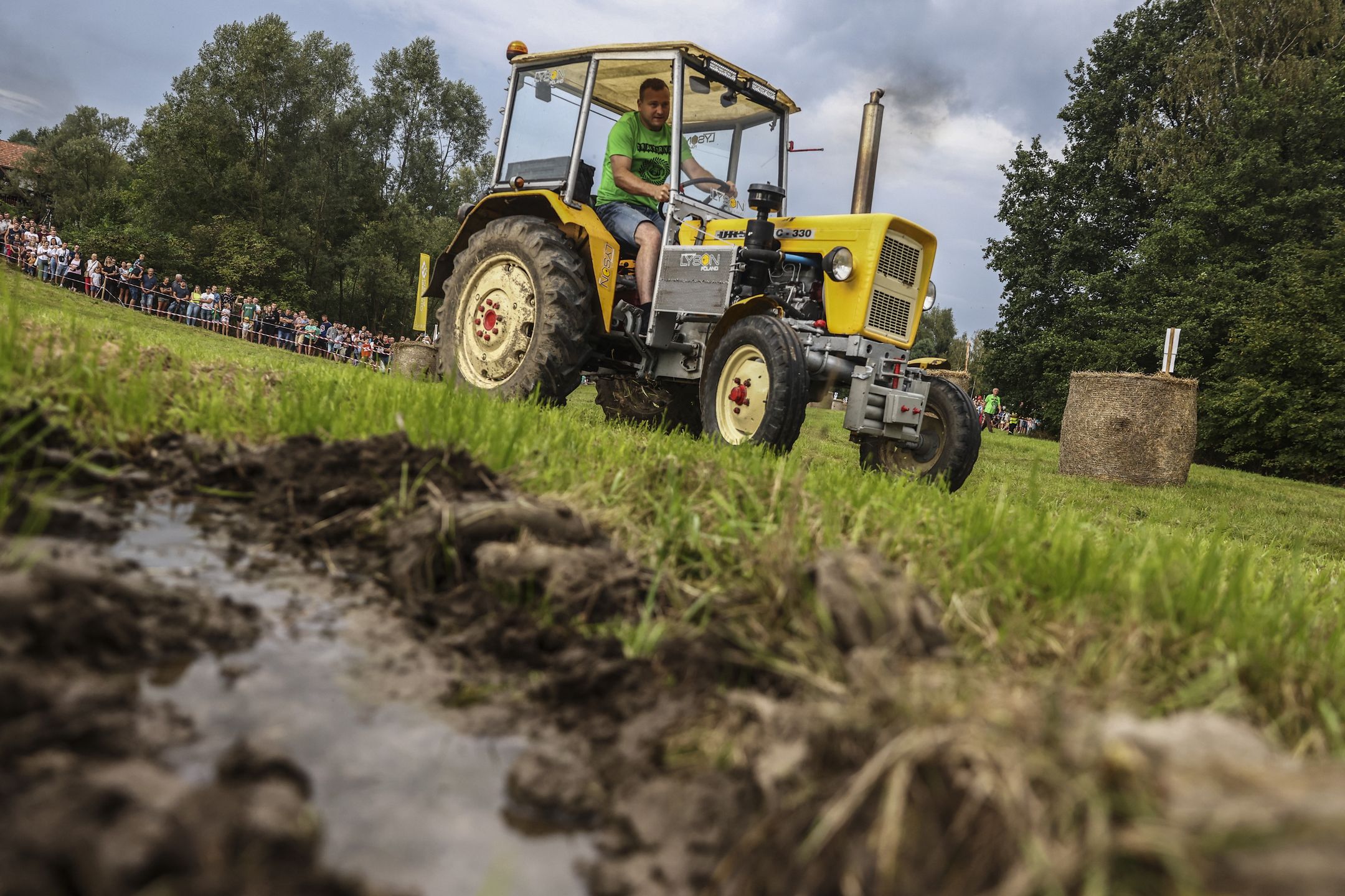 A participant attends a tractors race called 'Traktoryja' organized as part of traditional Dozhinki harvest festival. Gieraltowice, Wadowice County in Poland on August 28, 2022. Participants raced in five different classes according to engine power of a tractor. For the first time women took part in the race. (Photo by Beata Zawrzel/NurPhoto via Getty Images)