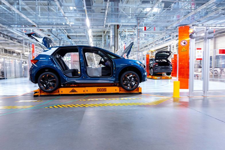 An automated guided vehicle (AGV) moves a Seat Cupra Born electric vehicle (EV) on the assembly line at the Volkswagen AG (VW) electric automobile plant in Zwickau, Germany, on Tuesday, April 26, 2022. The Zwickau assembly lines are the centerpiece of a plan by VW, the world's biggest automaker, to manufacture as many as 330,000 cars annually. Photographer: Krisztian Bocsi/Bloomberg via Getty Images