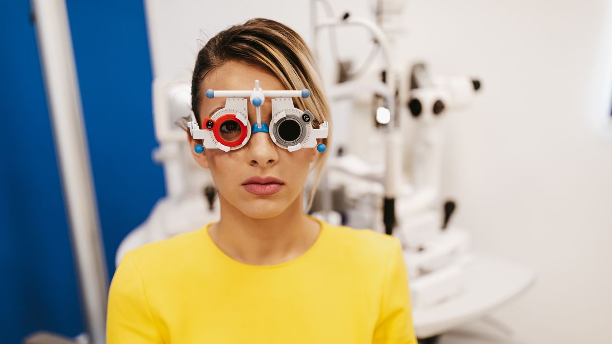 Beautiful young woman at ophthalmologist , Eyesight exam