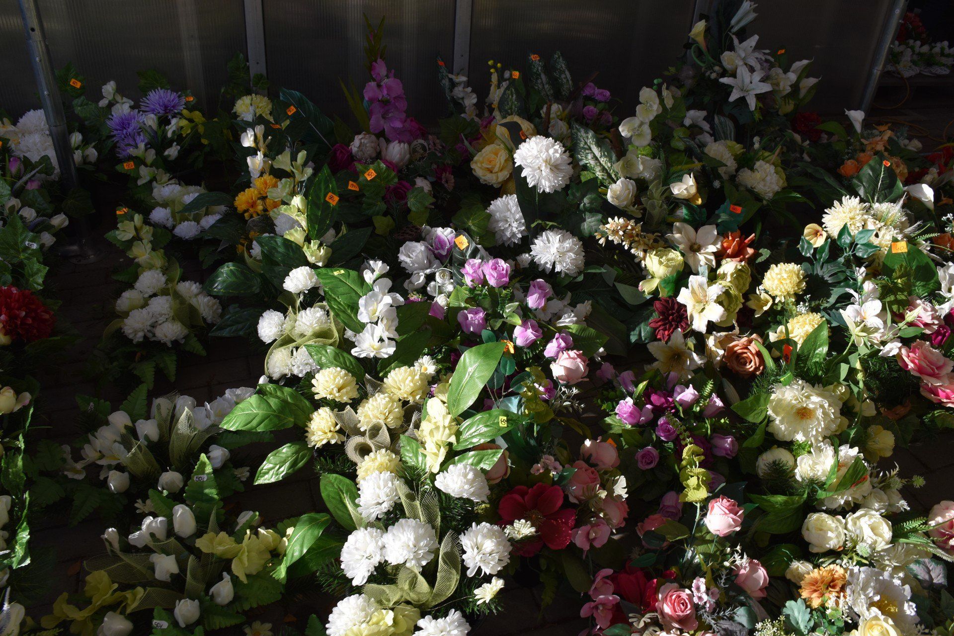 Wiele osób zdecydowało się zamówić kompozycje wcześniej w kwiaciarniach, ale przy cmentarzu można liczyć też na gotowe sztuczne wiązanki i zestawy kwiatów.