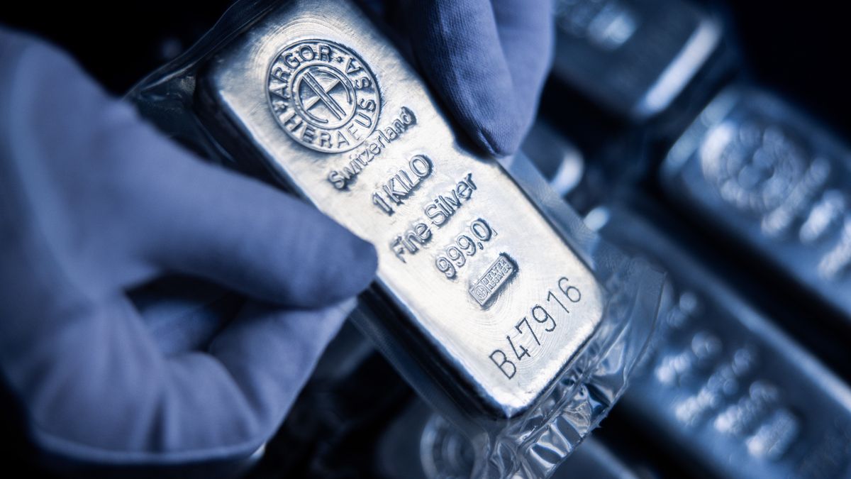 An attendant holds a one kilogram silver bar at Conclude Zrt bullion dealer arranged in Budapest, Hungary, on Monday, Feb. 17, 2025. Gold advanced, following its biggest one-day decline in two months, on nervousness over President Donald Trump's latest trade threats. Photographer: Akos Stiller/Bloomberg via Getty Images