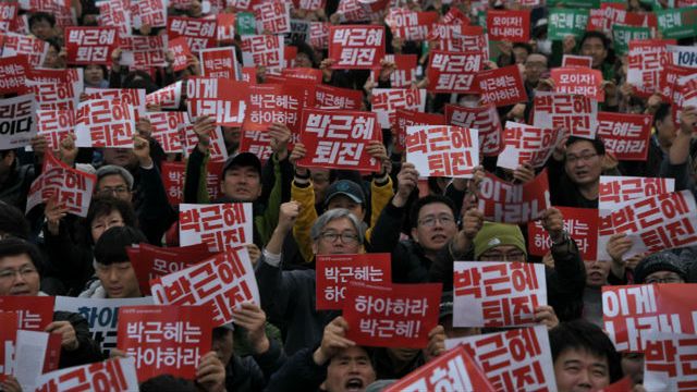 Demonstranci z hasłami nawołującymi do odejścia Park Geun-hye