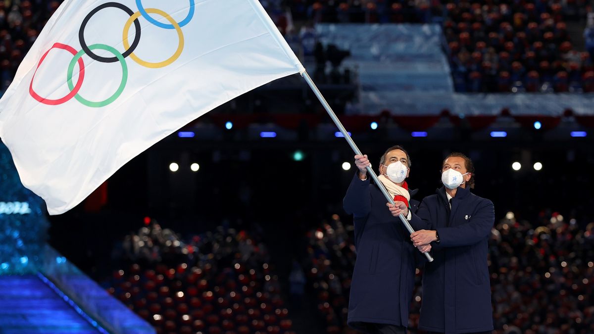 BEIJING, CHINA - FEBRUARY 20: Guiseppe Sala, Mayor of Milano city and Gianpetro Ghedina, Mayor of Cortina d' Ampezzo City wave the Olympic flag during the Beijing 2022 Winter Olympics Closing Ceremony on Day 16 of the Beijing 2022 Winter Olympics at Beijing National Stadium on February 20, 2022 in Beijing, China. (Photo by Maja Hitij/Getty Images)