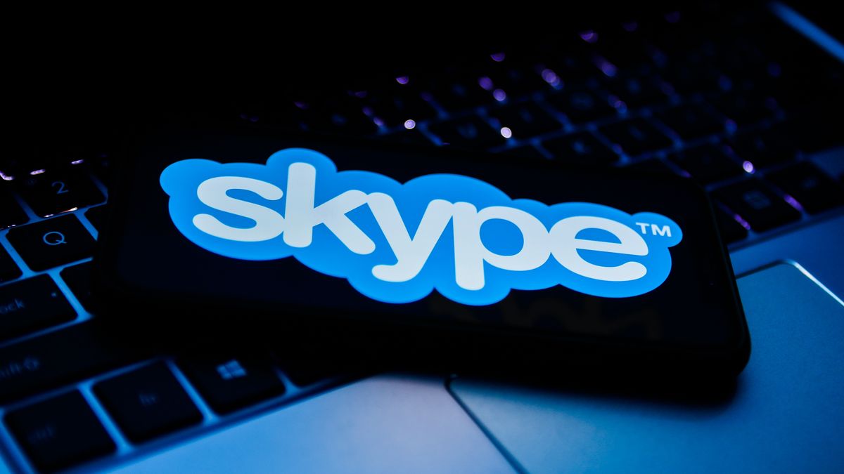 Skype logo displayed on a phone screen and a laptop keyboard are seen in this illustration photo taken in Sulkowice, Poland on August 27, 2021. (Photo Illustration by Jakub Porzycki/NurPhoto via Getty Images)