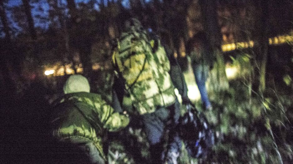 Group of illegal immigrants walk through the forest after crossing polish belarusian border near Michalowo on October 6, 2021. (Photo by Maciej Luczniewski/NurPhoto via Getty Images)
