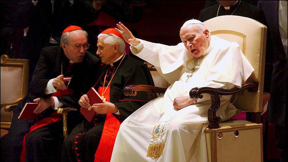 Pope John Paul II signed the Post-Synodal Apostolic Exhortation on the ministry of bishops during a meeting with cardinals and bishops at the Vatican the day of the 25th anniversary of his election in Rome, Italy on October 16th, 2003.
VATICAN - OCTOBER 16:  Cardinals Giovanni Battista Re (L) and Joseph Ratzinger in Rome, Italy on October 16th, 2003.  (Photo by Eric VANDEVILLE/Gamma-Rapho via Getty Images)
Eric VANDEVILLE
Anniversary, Cardinal, Christianity, Color, Color photo, German, Holy Father, Holy See, Italian, Jubilee, Minister of religion, Papacy, Pole, Pope, Religious personality, Sacred College, Salute Gesture, Supreme Pontiff, Synod, Waving, catholic religion Roman Catholic Church, pontiff, pontificate